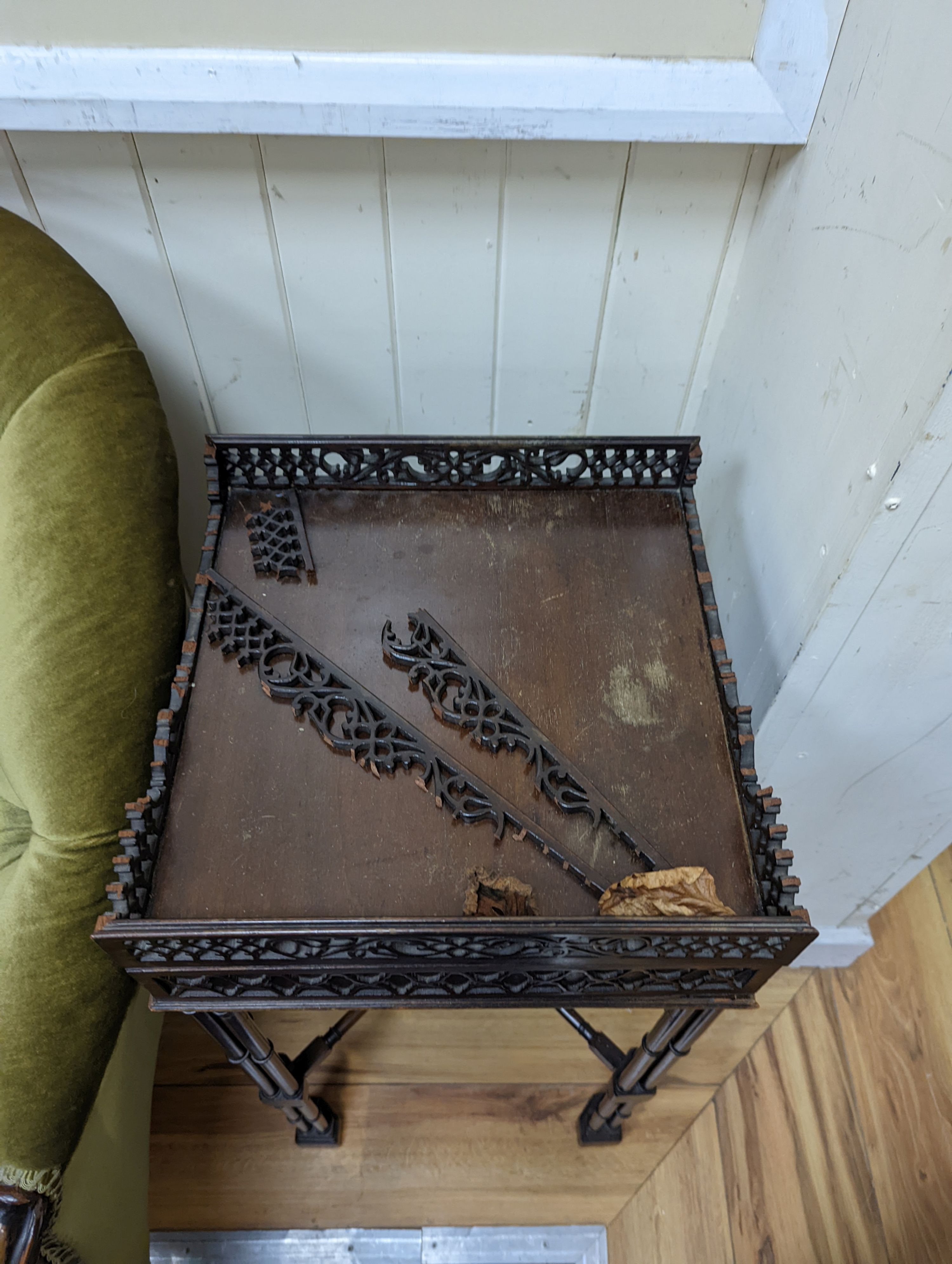 A pair of George III style square mahogany fret cut urn stands on cluster column legs, (one in need of repair) width 34cm, height 72cm